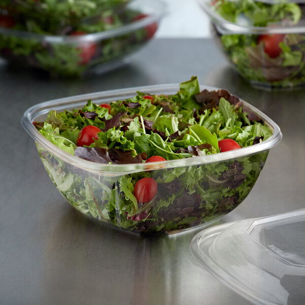 A salad in a clear Fineline plastic bowl.