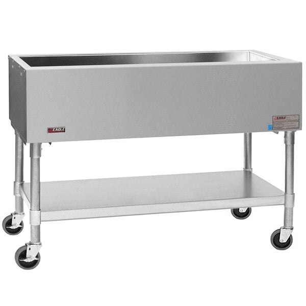 An Eagle Group stainless steel mobile cold food table with galvanized undershelf on wheels.