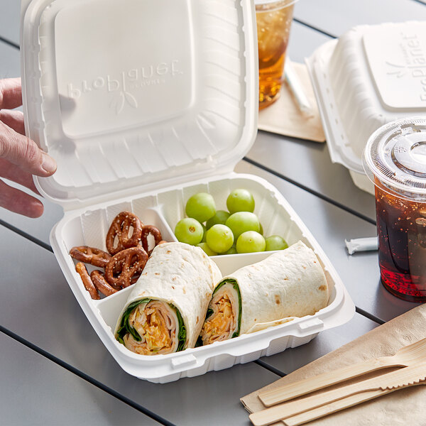 A white Dart ProPlanet takeout container with food inside.