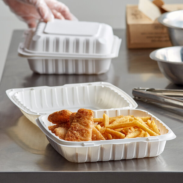 A white Dart ProPlanet takeout container with food in it.