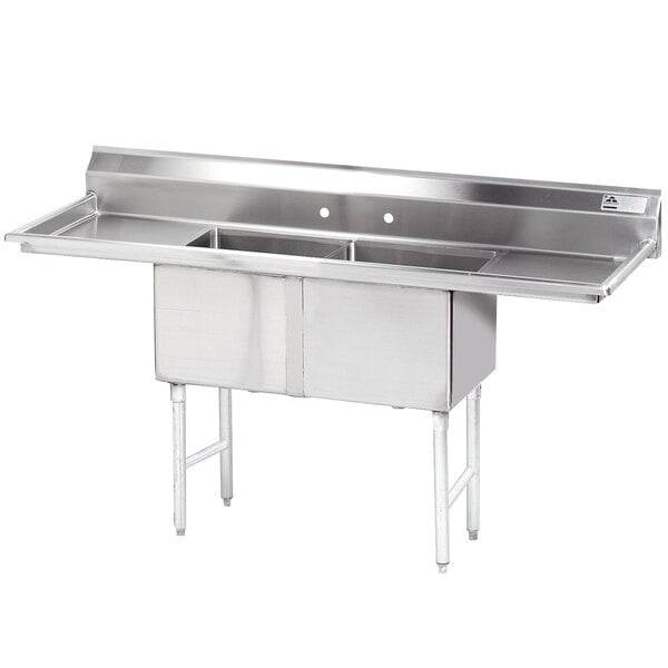 A stainless steel Advance Tabco commercial sink with two compartments and two drainboards.