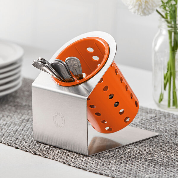 A Steril-Sil stainless steel flatware organizer with an orange plastic cylinder containing utensils.
