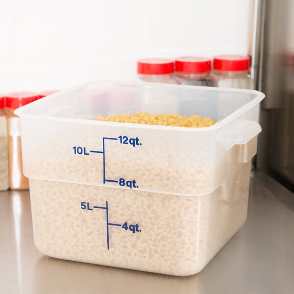 A close up of a Cambro translucent square polypropylene food storage container with measurements on it.