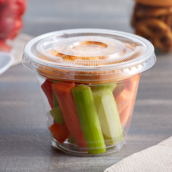 A clear plastic Choice cup with a 2 oz. insert filled with vegetables.