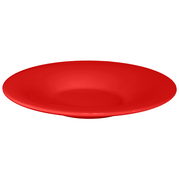 A red melamine pasta bowl with a white background.