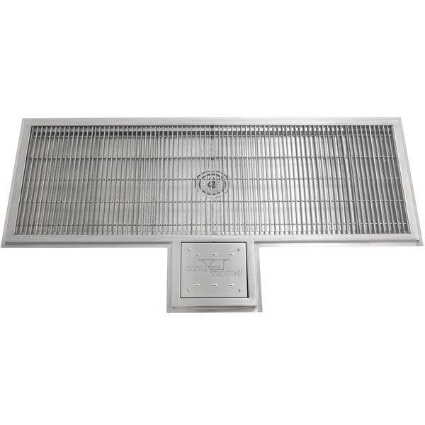 A stainless steel Eagle Group water tempering system with a metal grate over a drain.