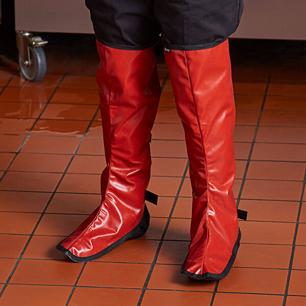 A person wearing red boots in a kitchen wearing San Jamar EZ-KLEEN® shin guards.