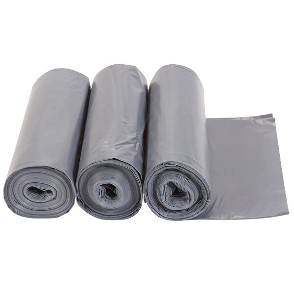 A roll of grey Rubbermaid plastic trash can liners.
