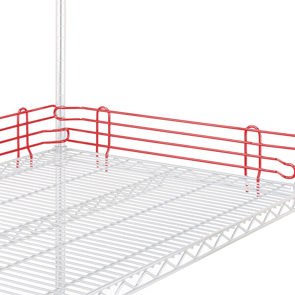 A white Metro wire shelf with red ledges and a red handle.