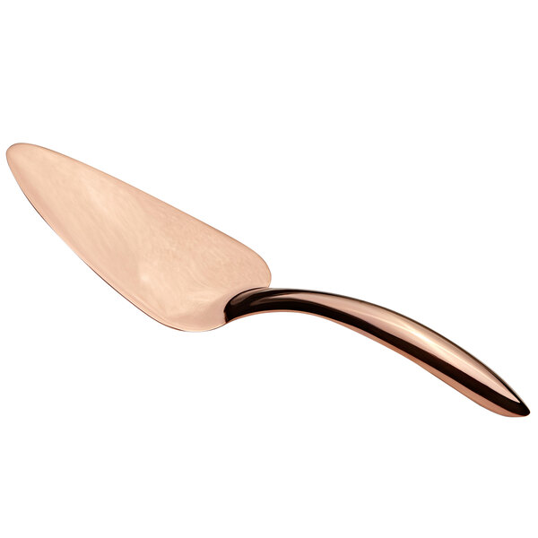 A close-up of a Bon Chef rose gold pastry server with a curved metal handle.