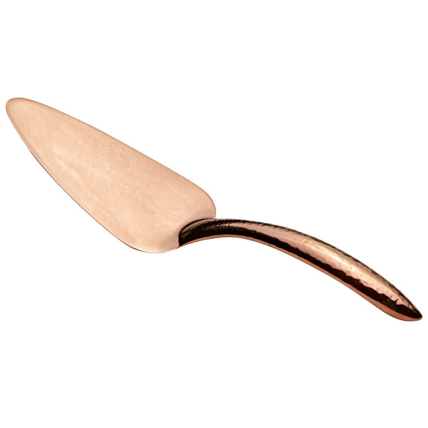 A close-up of a Bon Chef rose gold pastry server with a hammered handle.