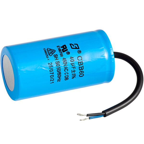 A blue capacitor with black wires.