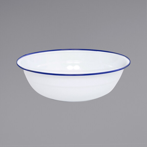 A white Crow Canyon Home enamelware basin with blue rolled rim.