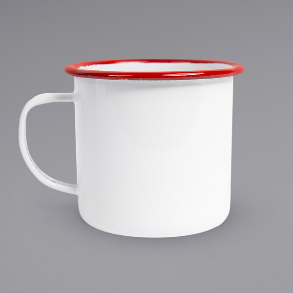 A white enamel mug with red rolled rim.
