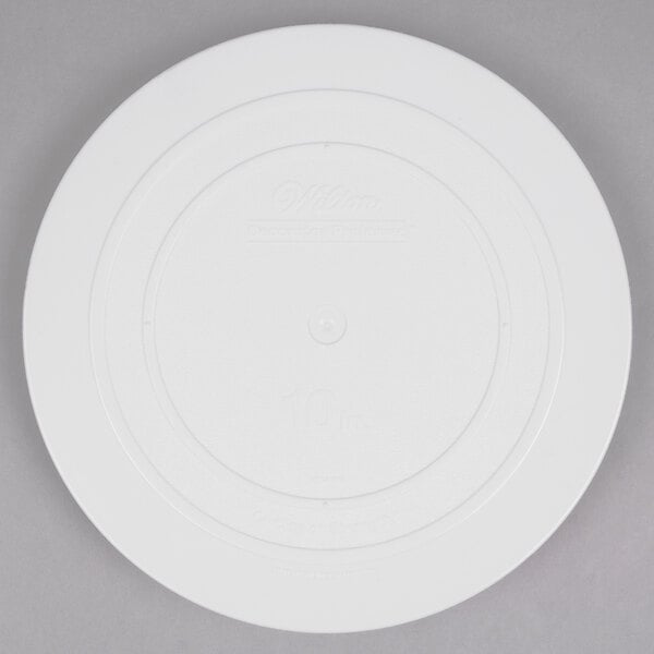 A white plastic Wilton round cake separator plate.