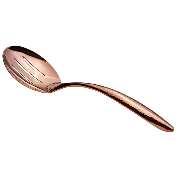 A close-up of a Bon Chef rose gold slotted serving spoon with a hollow handle.