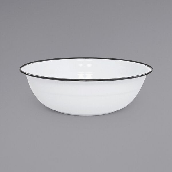 A Crow Canyon Home white enamelware basin with a black rim.