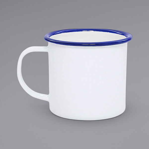 A white enamel mug with a blue rim.