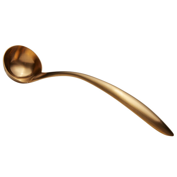 A gold ladle with a long handle.