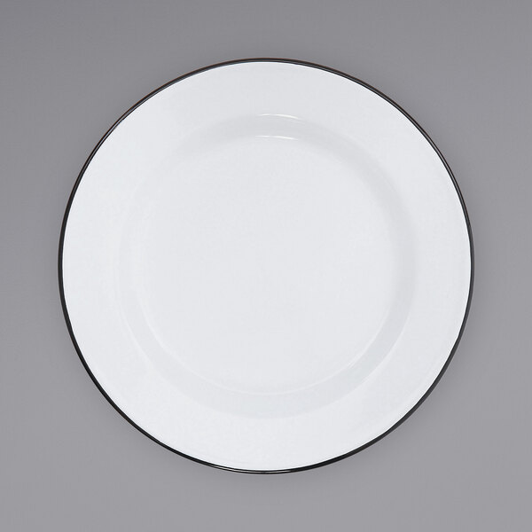 A white Crow Canyon Home enamelware plate with a black rim.