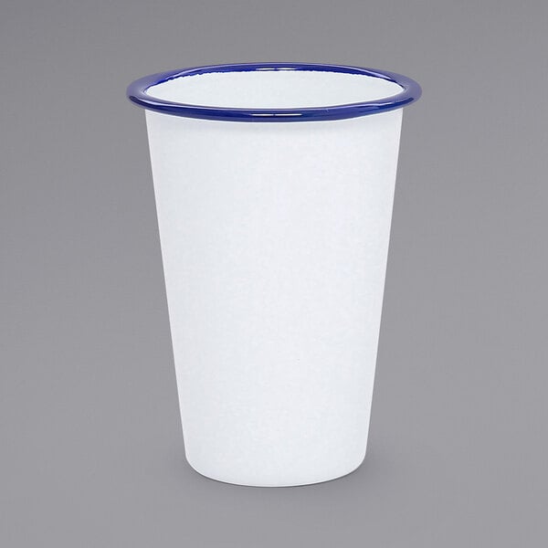 A white cup with blue rim.