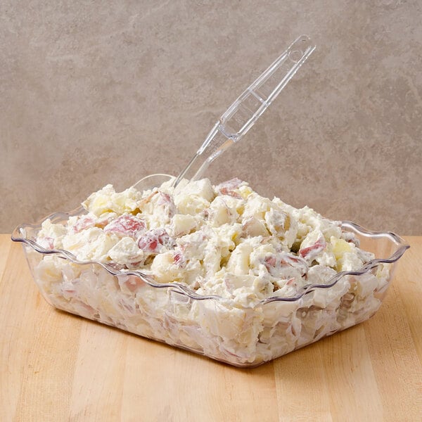 A clear plastic Cambro deli crock filled with potato salad.