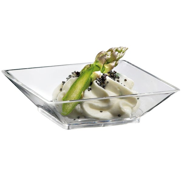 A clear Solia mini square plate with food in it.