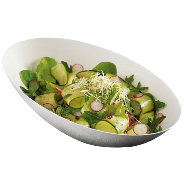 A Solia Cocoon sugarcane pulp bowl filled with salad including radishes, sprouts, and cucumber slices.