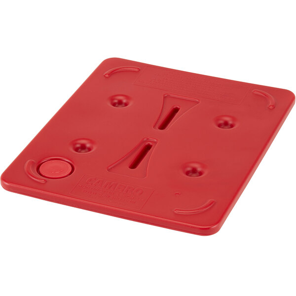 A red plastic Camwarmer with two holes.