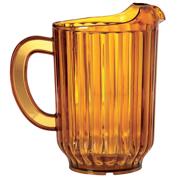 An amber plastic pitcher with a handle.