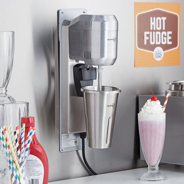 An AvaMix milkshake machine with a drink in a cup.