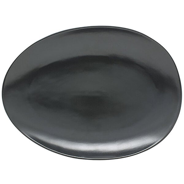 A black oval porcelain plate with a circular design in the middle.