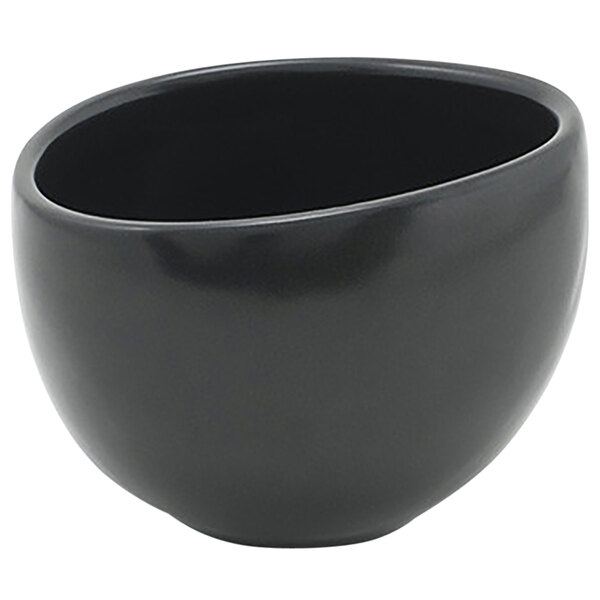A close up of a black bowl with a curved edge.