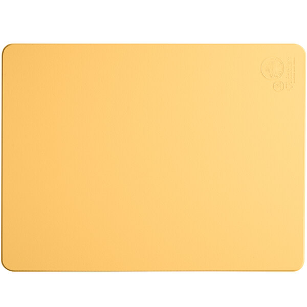 A yellow rectangular Tomlinson Chef's Edge cutting board with a logo on it.