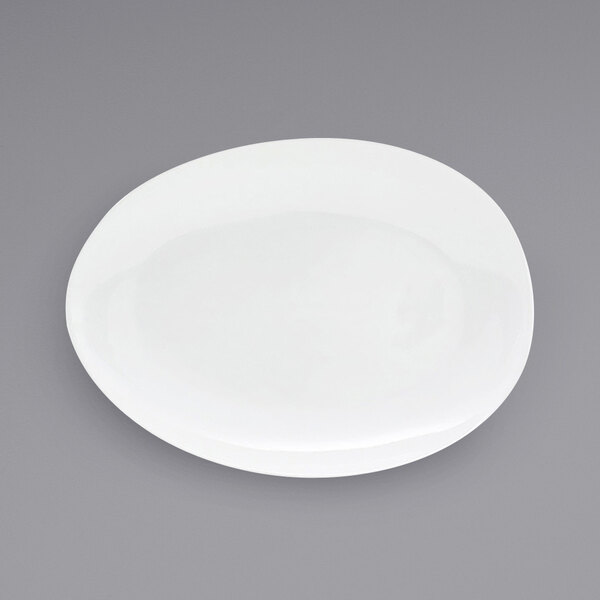 A white Front of the House Tides oval porcelain platter on a gray surface.