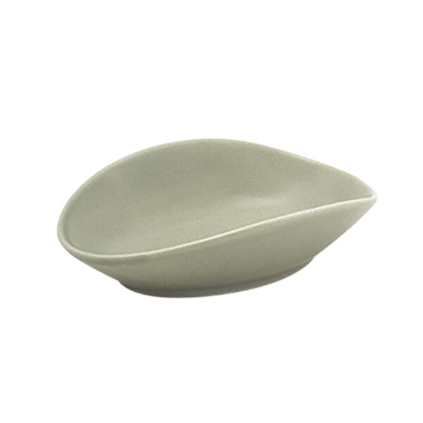 A Front of the House Tides semi-matte oval porcelain ramekin with curved edges.