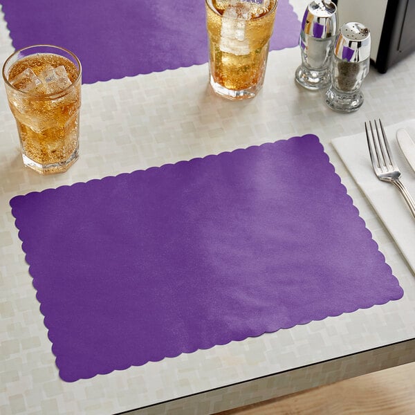 A purple scalloped paper placemat on a table with glasses of ice.