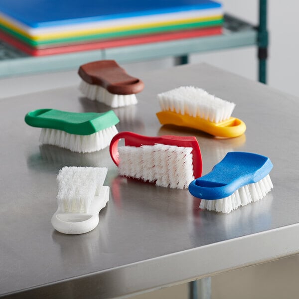 A Thunder Group 6-piece color-coded cutting board brush kit on a table.