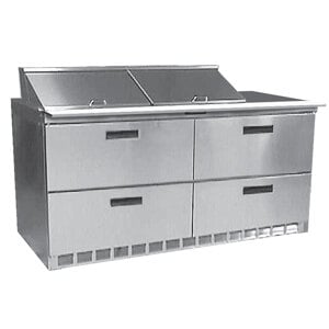 A stainless steel Delfield refrigerated sandwich prep table with four drawers.
