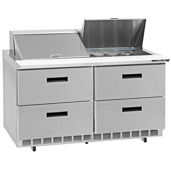 A Delfield stainless steel food prep table with four drawers.