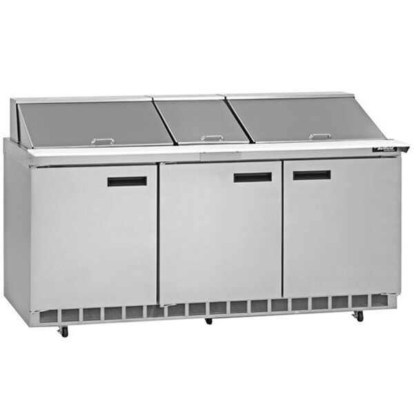 A stainless steel Delfield refrigerator with three doors.