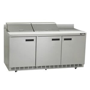 A Delfield stainless steel refrigerated sandwich prep table with three doors on a counter.