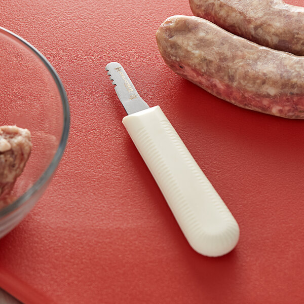 A Dexter-Russell Frankfurt Skinner knife cutting sausage.