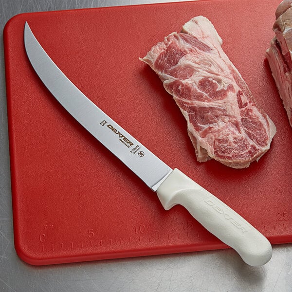 A Dexter-Russell Sani-Safe Narrow Breaking Knife cutting meat on a cutting board.