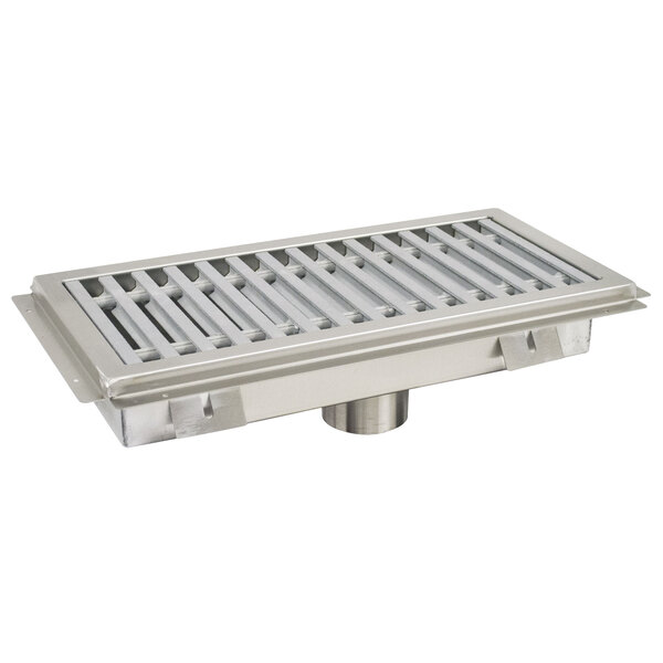A stainless steel Advance Tabco floor trough with a fiberglass drain grate over the drain hole.