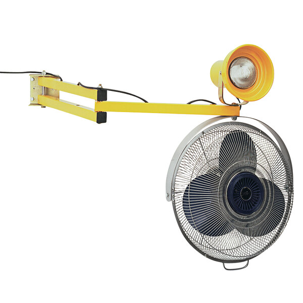 A yellow wall mounted Wesco Industrial Products fan with a light on it.