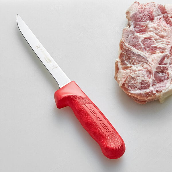 A Dexter-Russell narrow boning knife with a red handle next to a piece of meat.