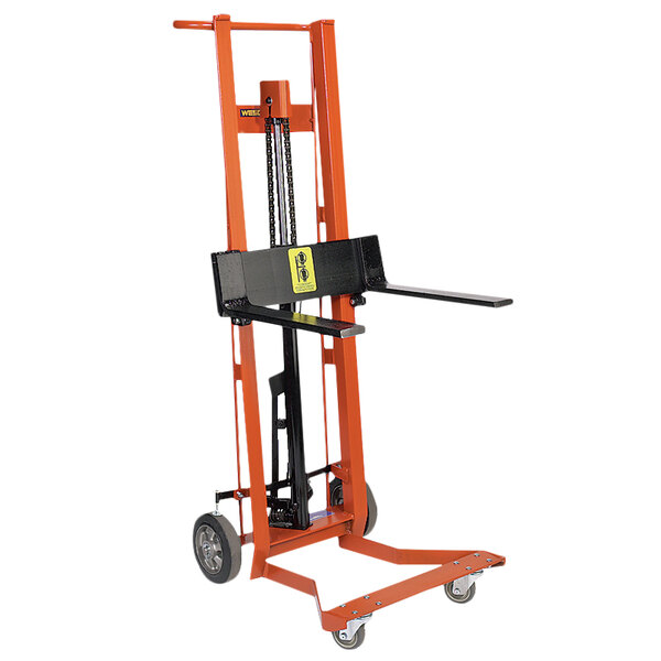A Wesco Industrial Products hydraulic pedalift with black and orange forks and wheels.
