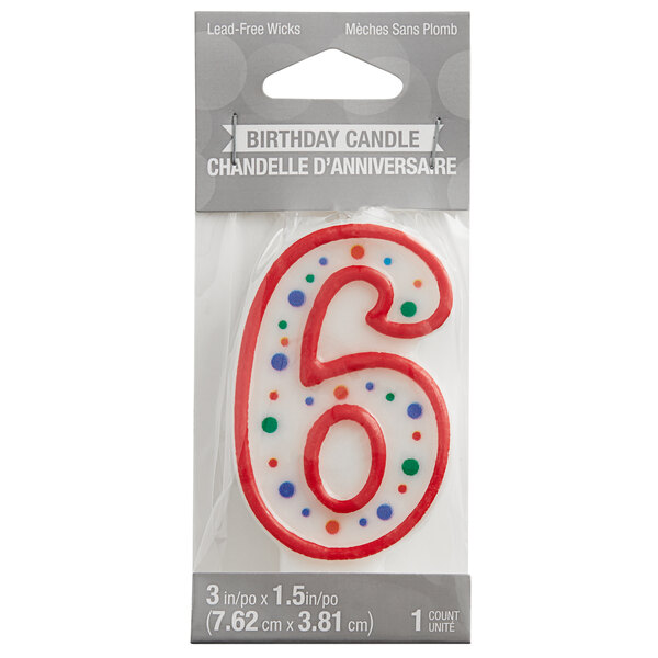 A red and white birthday candle with a polka dot number six on it in a package.
