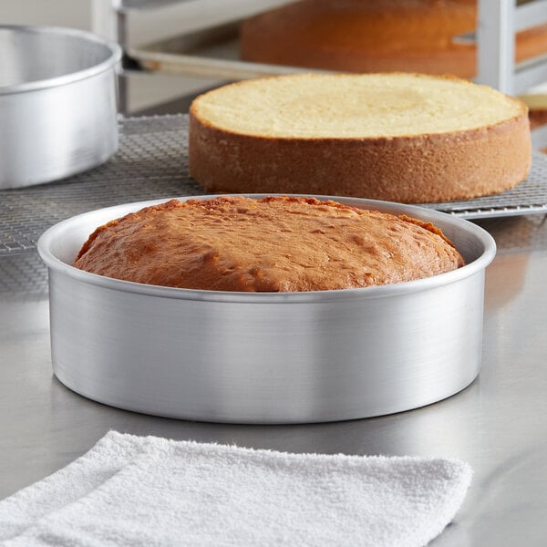 A Baker's Mark cheesecake in an aluminum cake pan with a removable bottom.